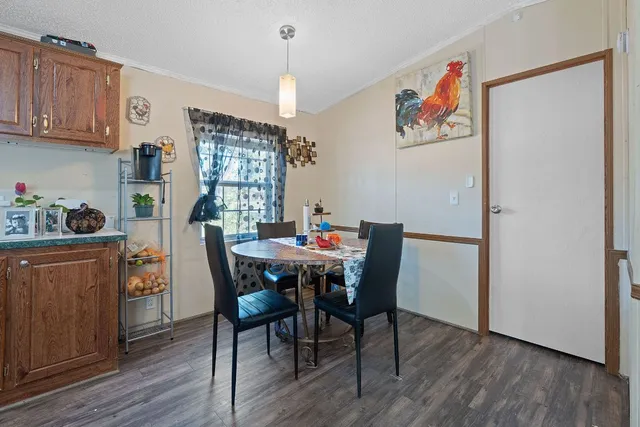 a dining room with furniture and wooden floor