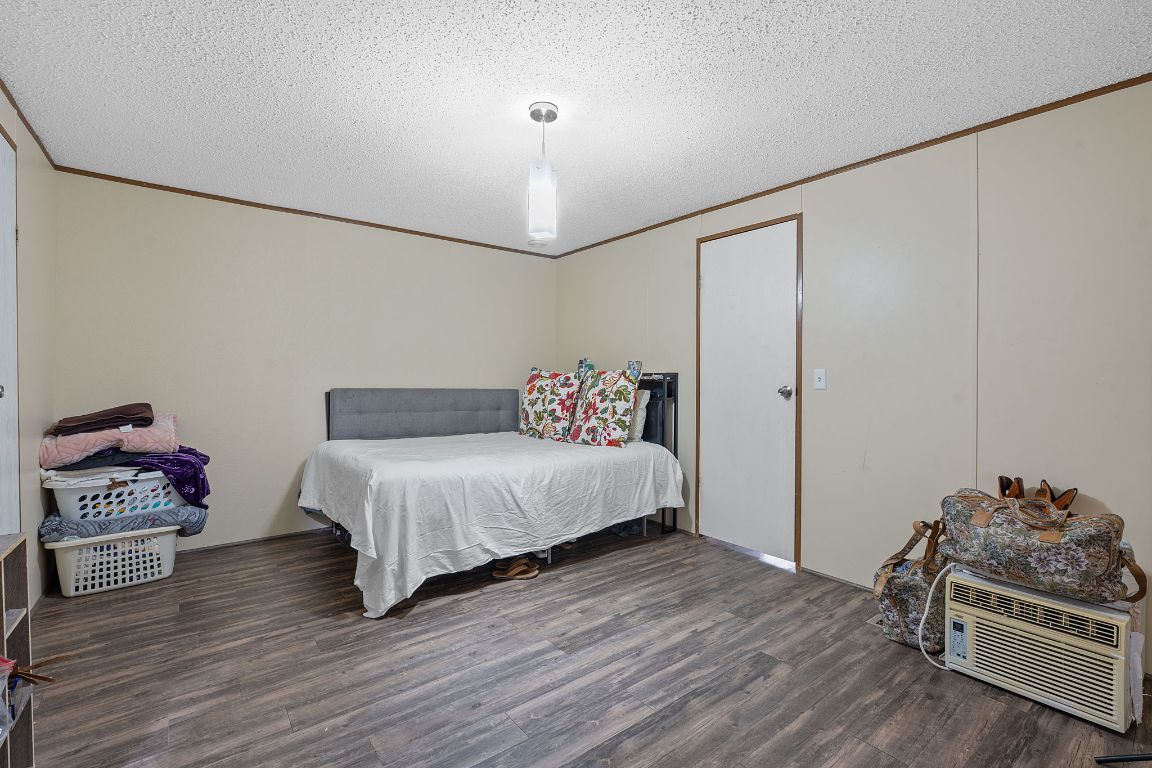 155 Forister Ranch Drive Dale, TX 78616 - Photo 15 of 30 a spacious bedroom with a bed and a chair in it