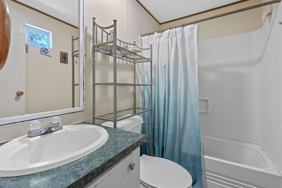 155 Forister Ranch Drive Dale, TX 78616 - Photo 22 of 30 a bathroom with a granite countertop sink toilet and shower