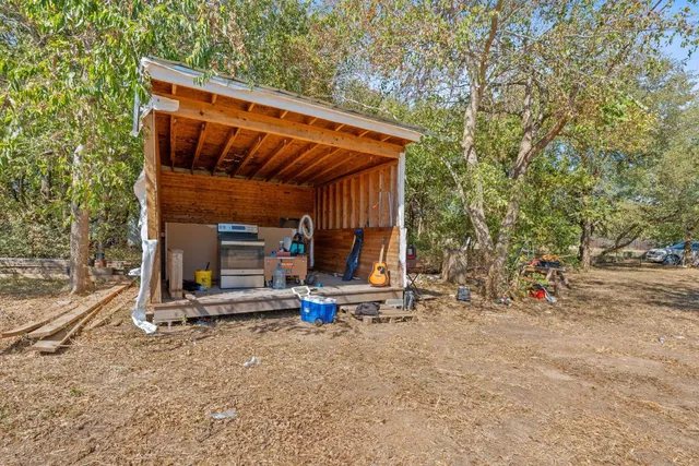 a view of a two chairs in the backyard