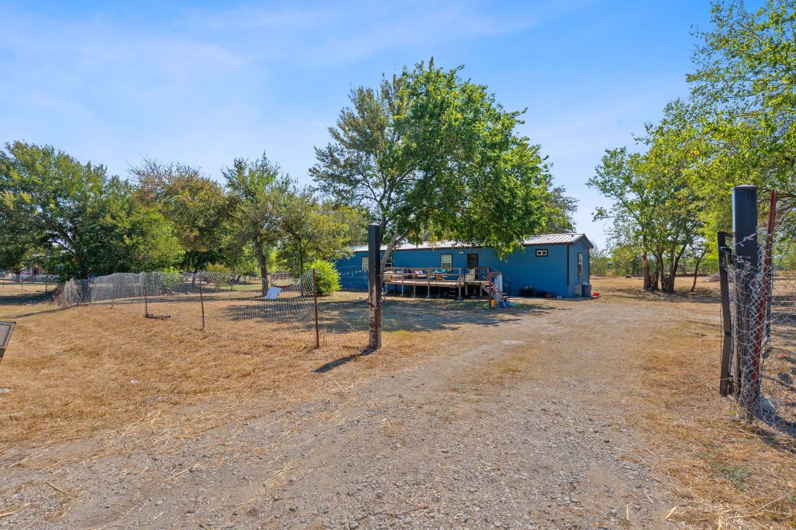 155 Forister Ranch Drive Dale, TX 78616 - Photo 4 of 30 a view of backyard with outdoor seating and trees in the background