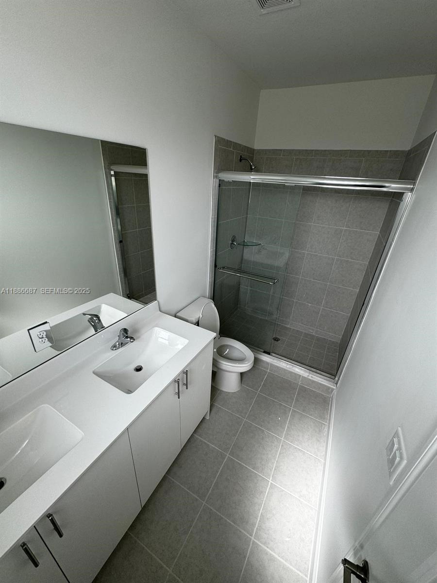 16270 Southwest 292nd Street Homestead, FL 33033 - Photo 15 of 29 a bathroom with a sink a toilet and shower