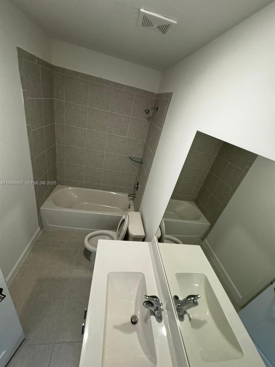 16270 Southwest 292nd Street Homestead, FL 33033 - Photo 18 of 29 a bathroom with a bathtub and shower
