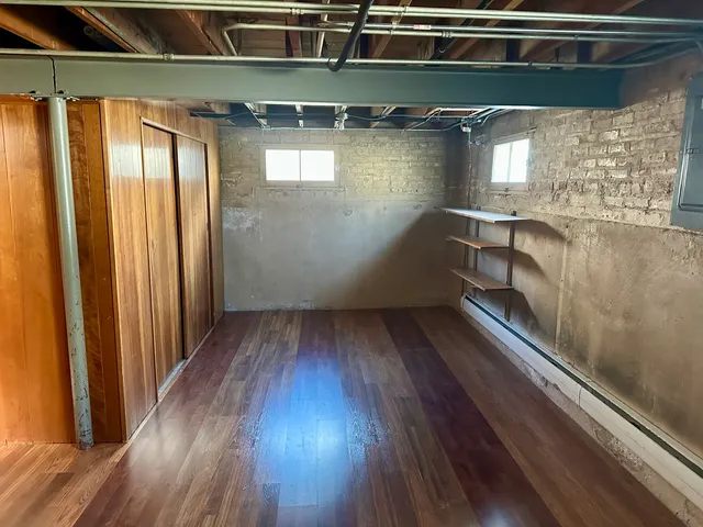 a view of a room with wooden floor
