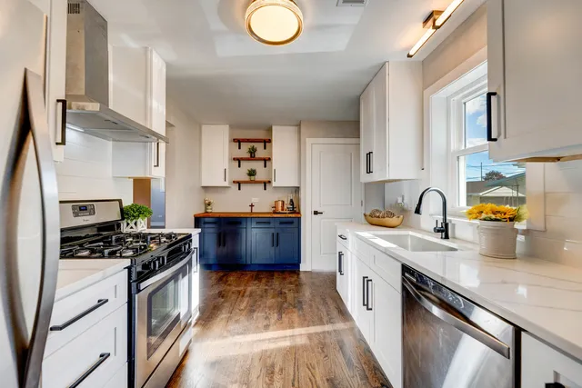 a kitchen with stainless steel appliances a sink stove and cabinets
