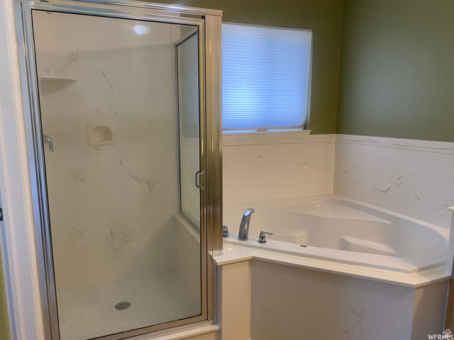 83 Canterbury Circle Logan, UT 84321 - Photo 18 of 23 Full bath featuring a marble finish shower and a garden tub