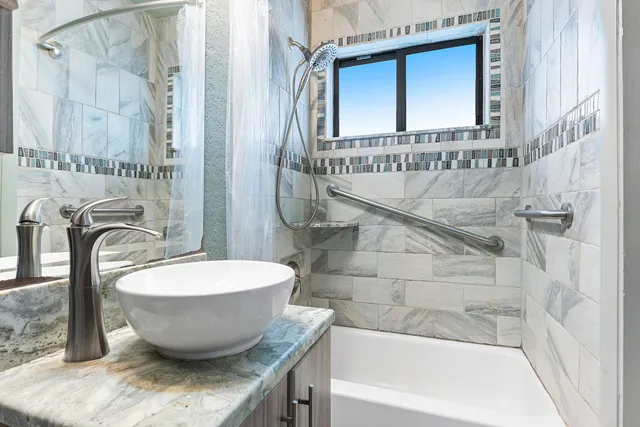 a view of a bathroom with a tub and shower