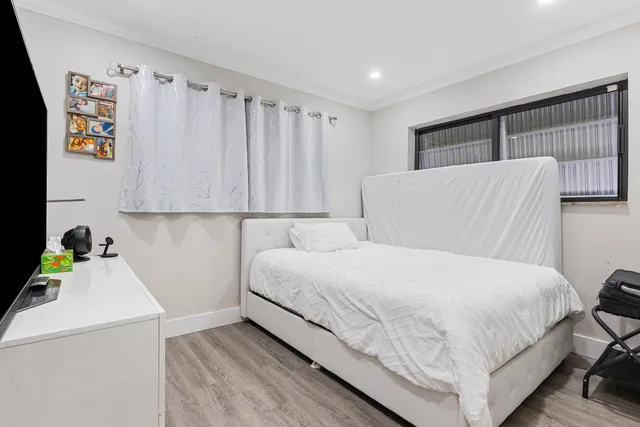 a bedroom with a bed and a dresser