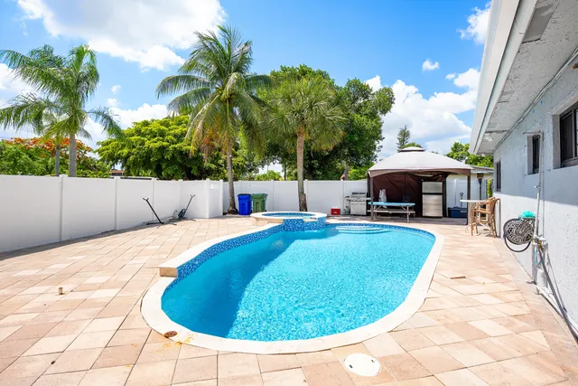 a swimming pool with outdoor seating and yard