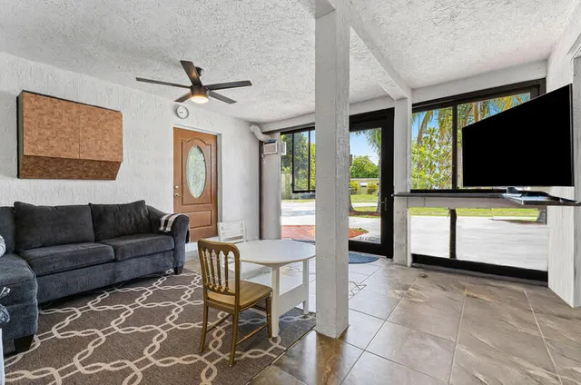 a living room with furniture and a flat screen tv