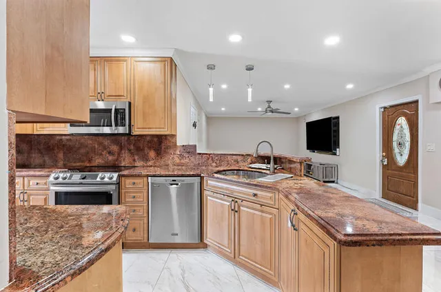 a kitchen with a stove sink and microwave