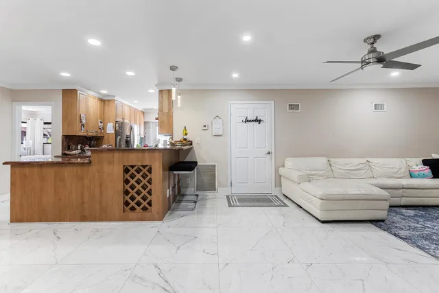 a living room with furniture and kitchen view