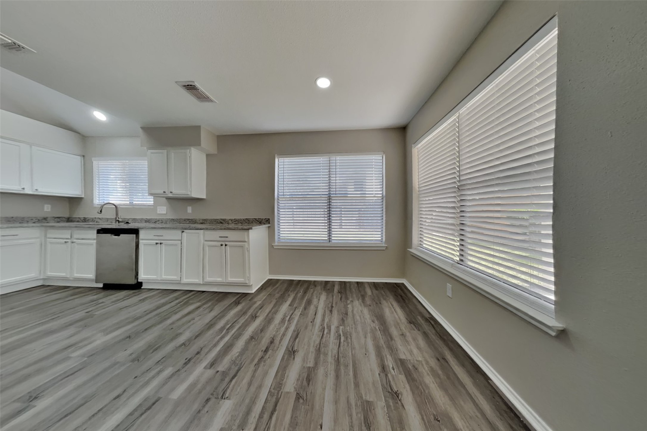 17030 Highworth Drive Spring, TX 77379 - Photo 11 of 24 a kitchen with wooden floors and white appliances