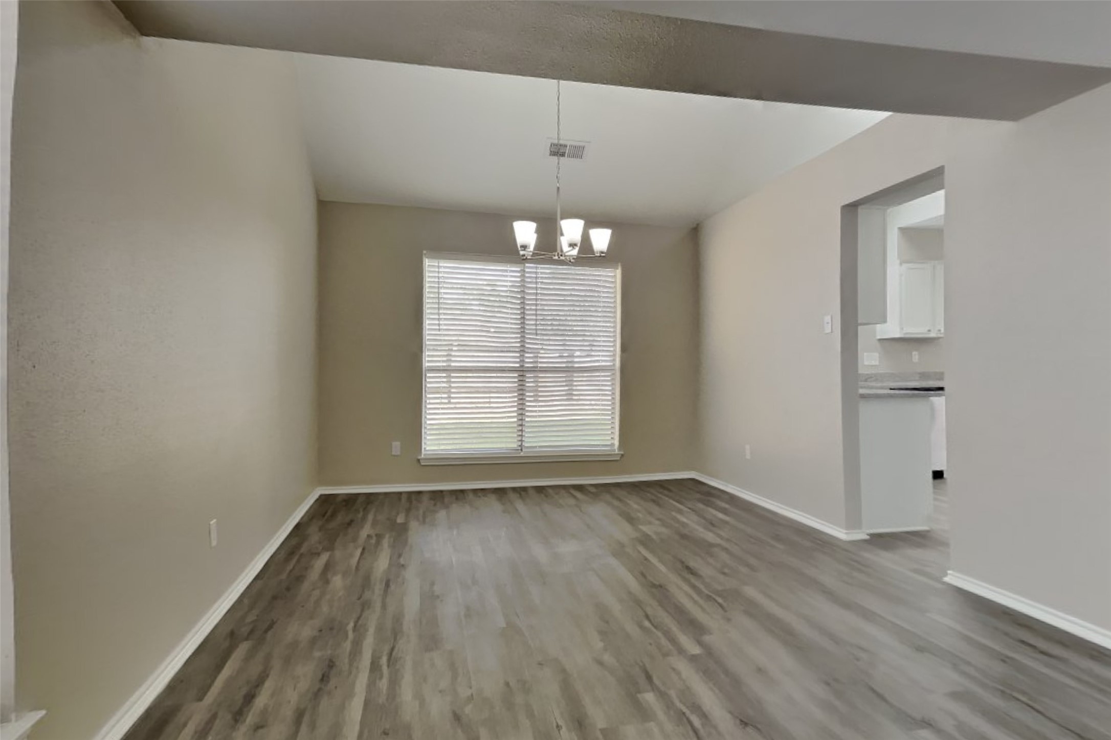 17030 Highworth Drive Spring, TX 77379 - Photo 13 of 24 a view of an empty room with wooden floor and a window