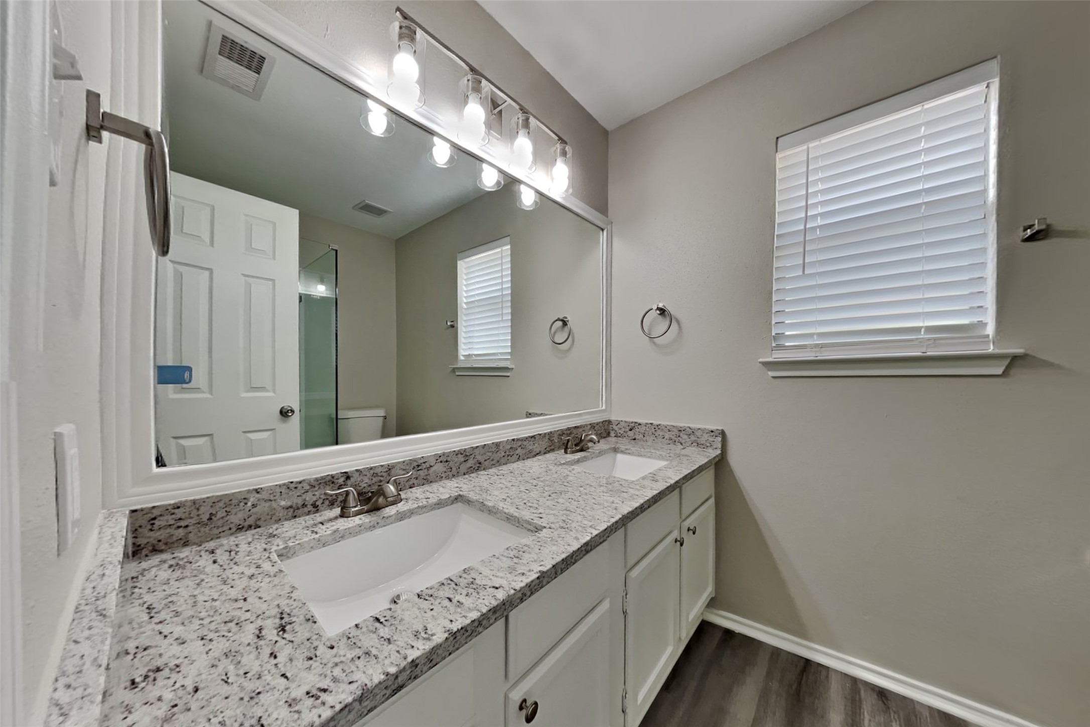 17030 Highworth Drive Spring, TX 77379 - Photo 17 of 24 a bathroom with a granite countertop sink and a mirror