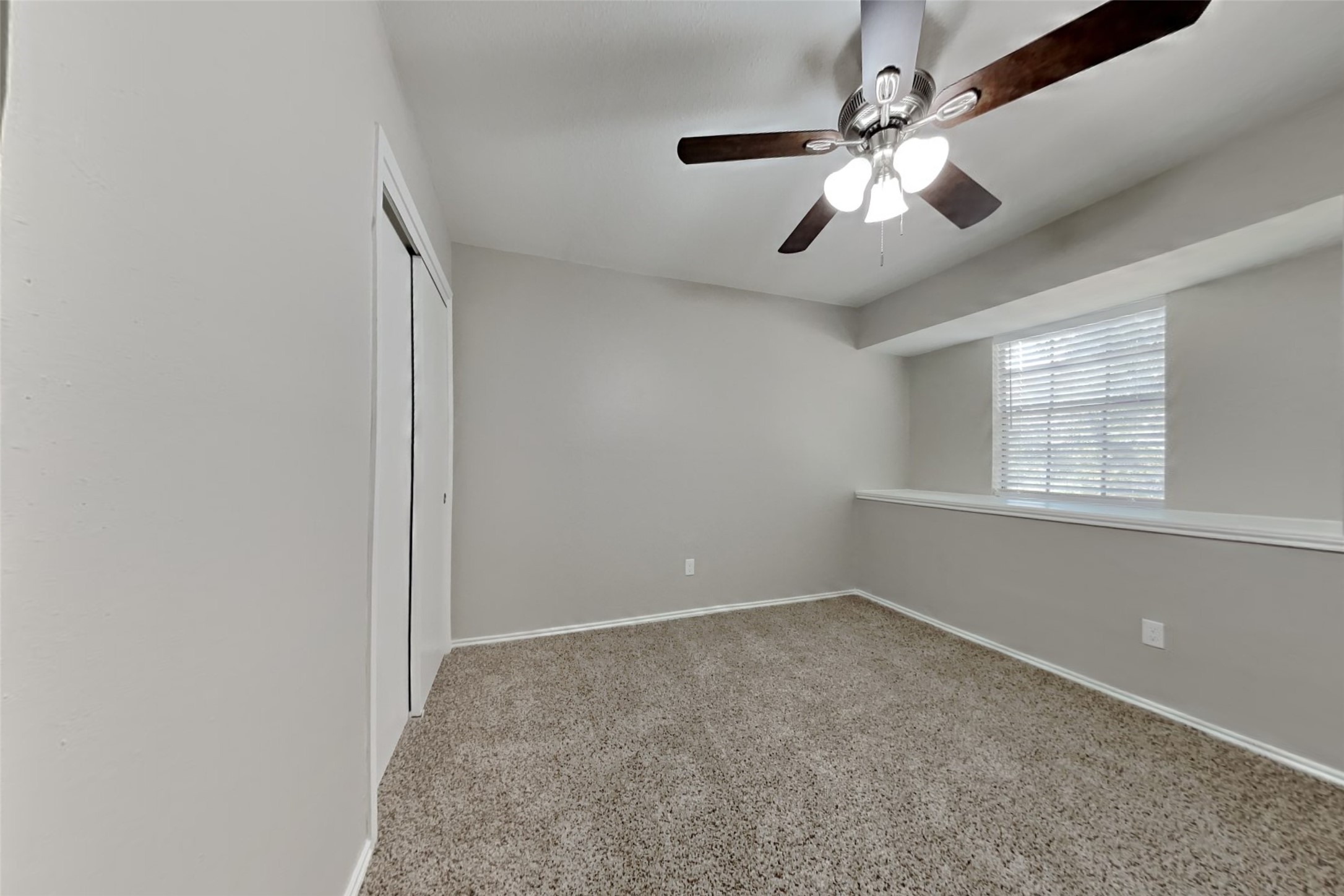 17030 Highworth Drive Spring, TX 77379 - Photo 18 of 24 an empty room with windows and fan