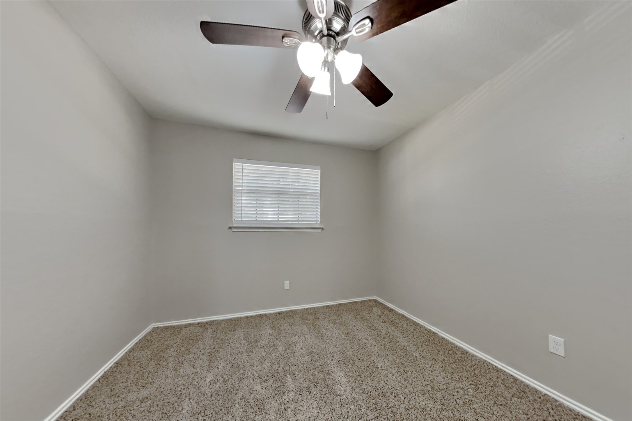 17030 Highworth Drive Spring, TX 77379 - Photo 20 of 24 an empty room with a chandelier fan and windows