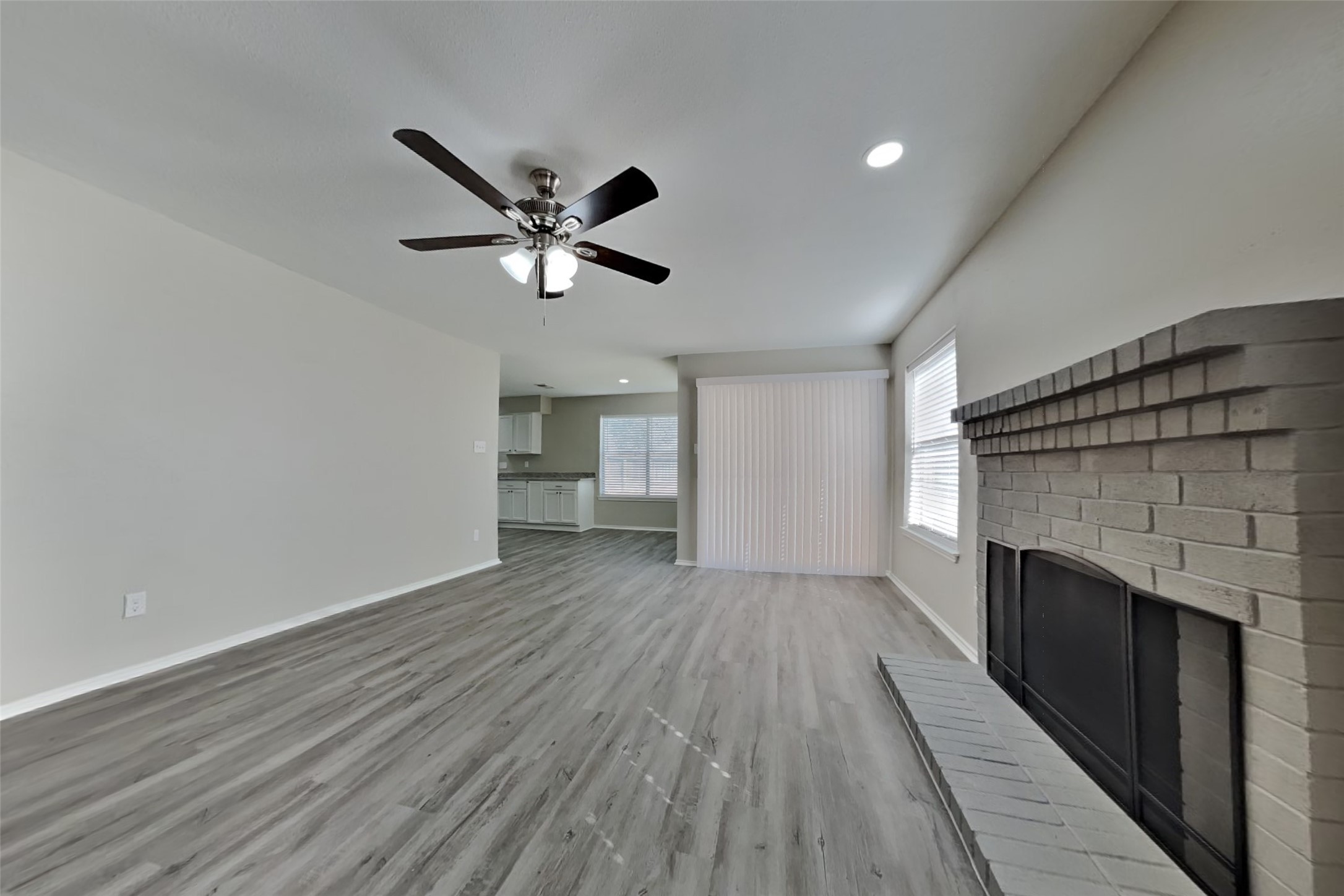 17030 Highworth Drive Spring, TX 77379 - Photo 2 of 24 a view of empty room with wooden floor and fireplace