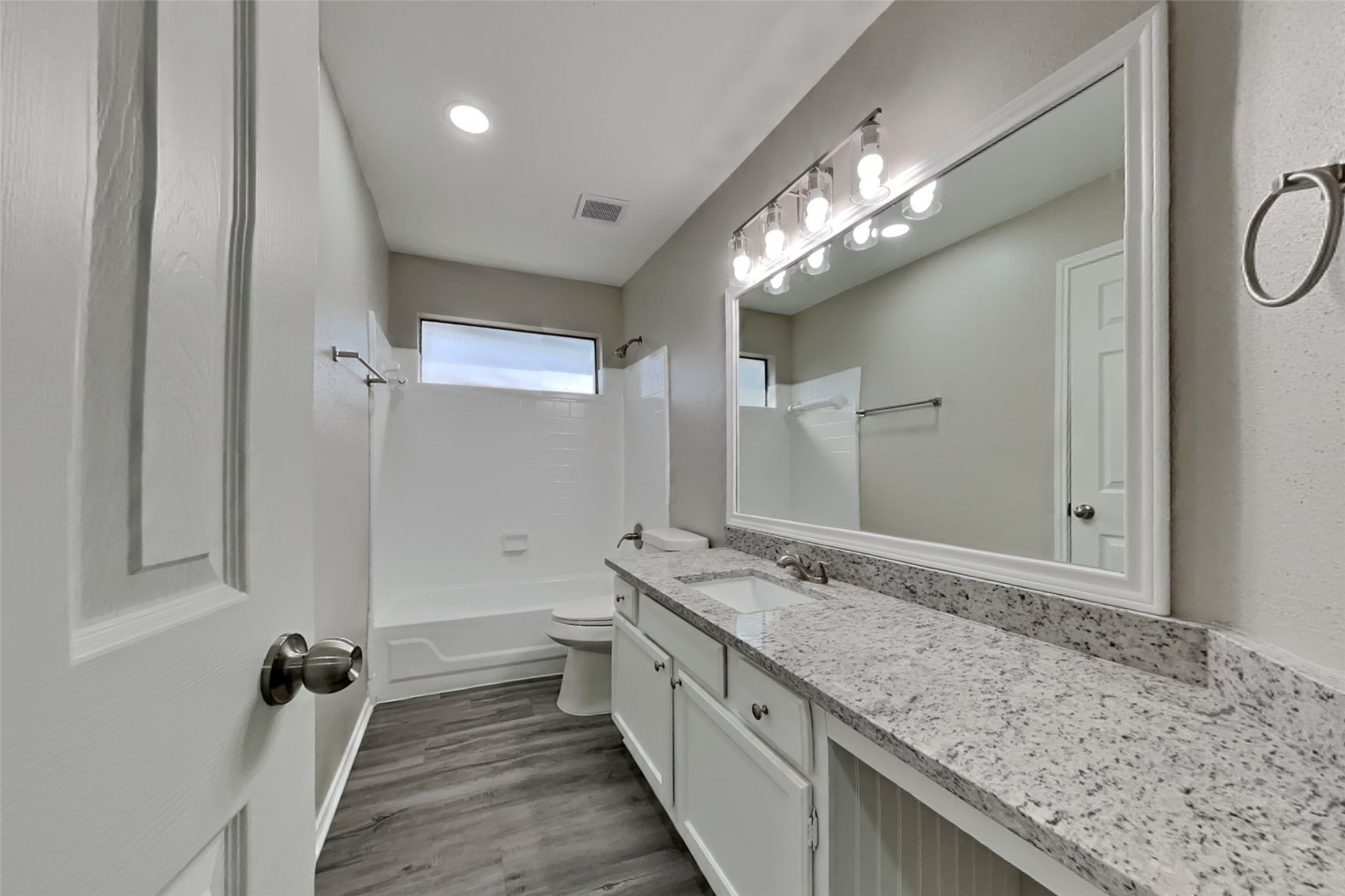 17030 Highworth Drive Spring, TX 77379 - Photo 21 of 24 a bathroom with a granite countertop sink a large mirror and a shower