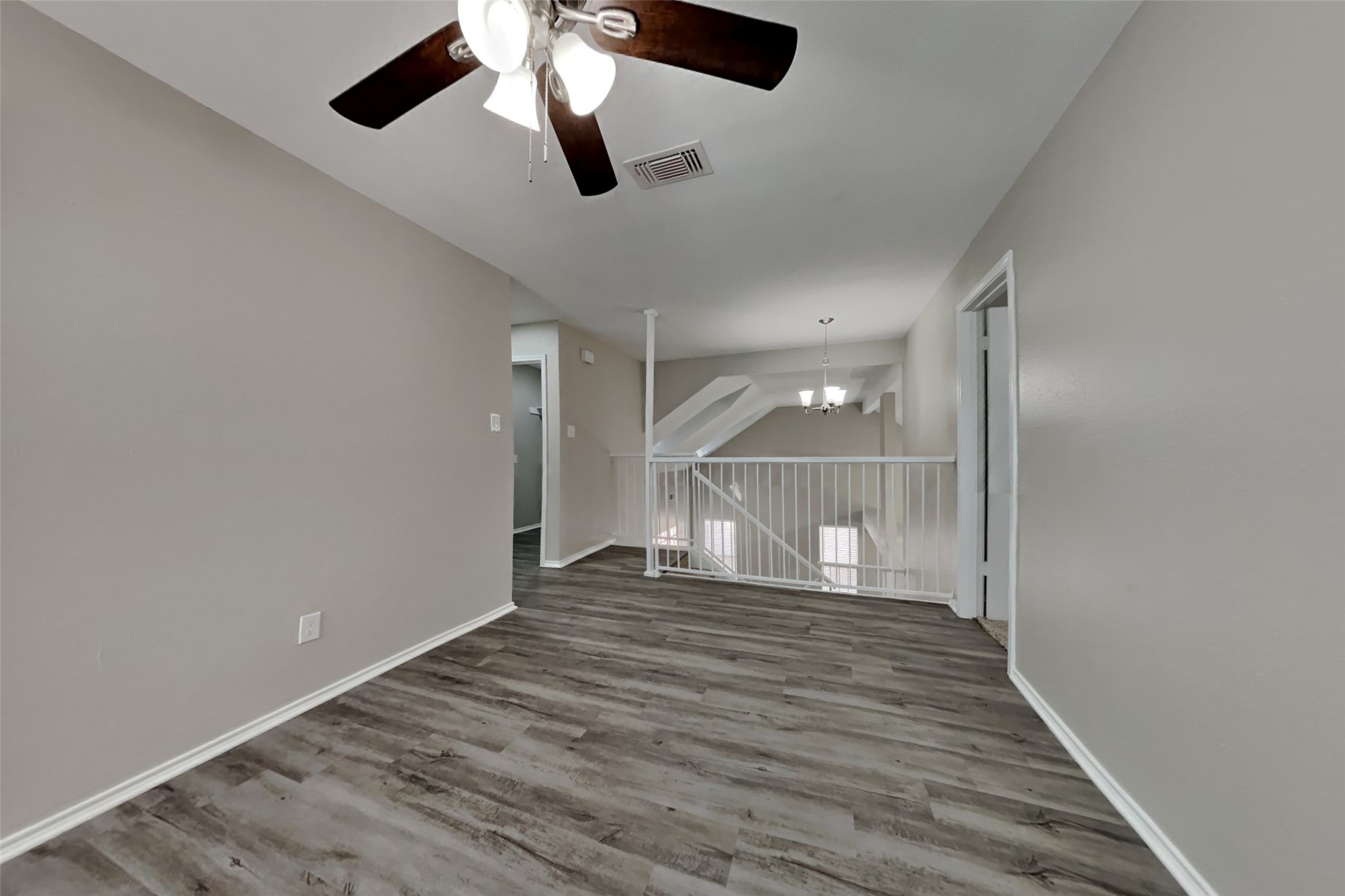 17030 Highworth Drive Spring, TX 77379 - Photo 7 of 24 an empty room with wooden floor and windows
