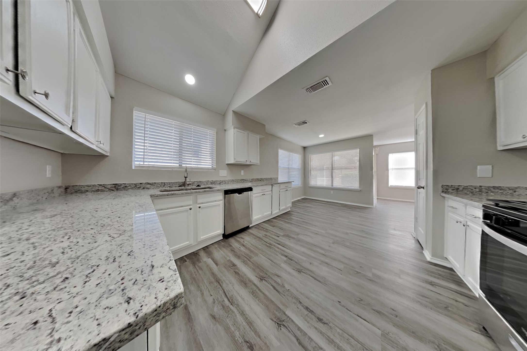17030 Highworth Drive Spring, TX 77379 - Photo 9 of 24 a large kitchen with cabinets wooden floor and stainless steel appliances