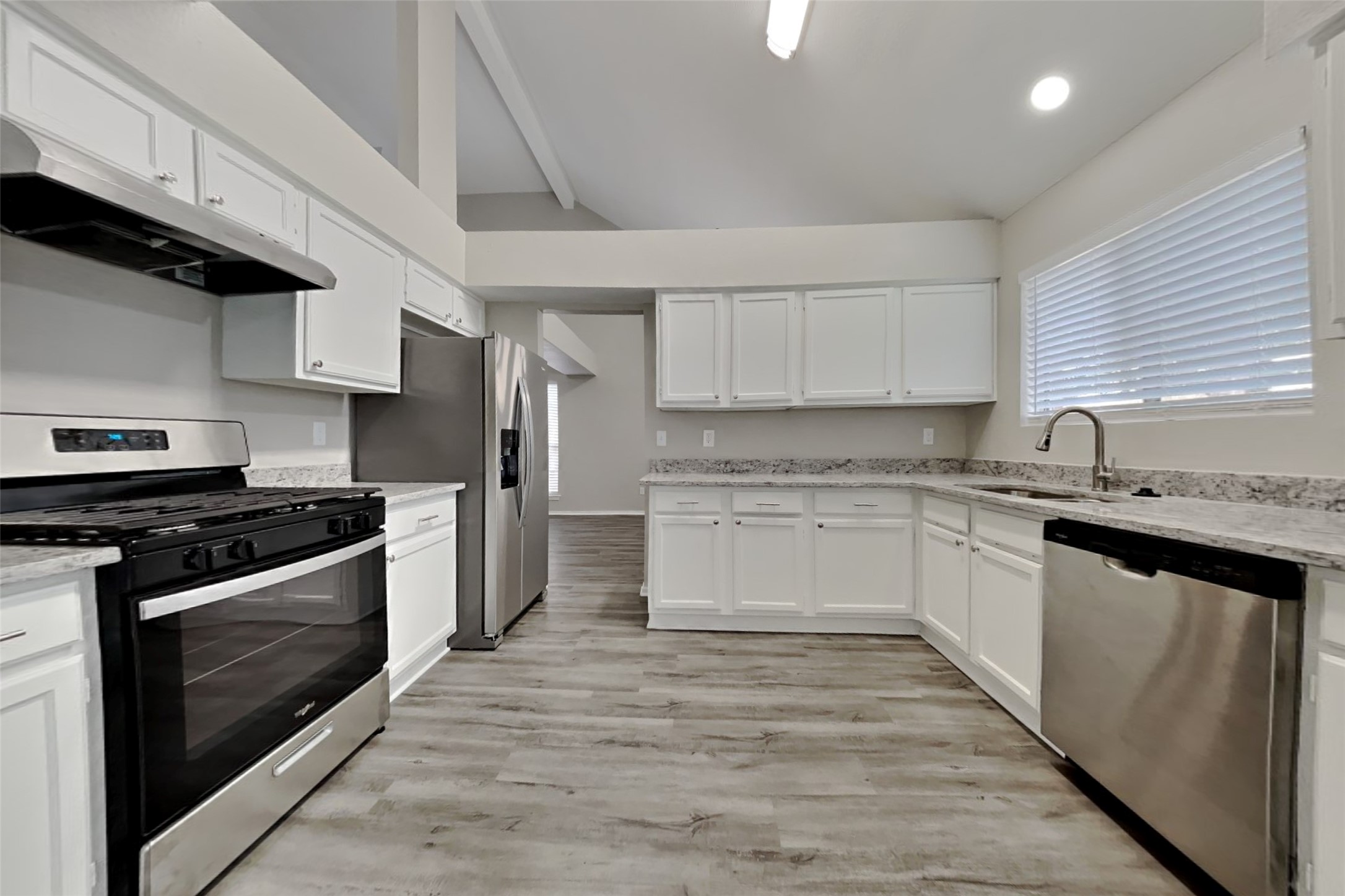 17030 Highworth Drive Spring, TX 77379 - Photo 10 of 24 a kitchen with granite countertop wooden cabinets and stainless steel appliances