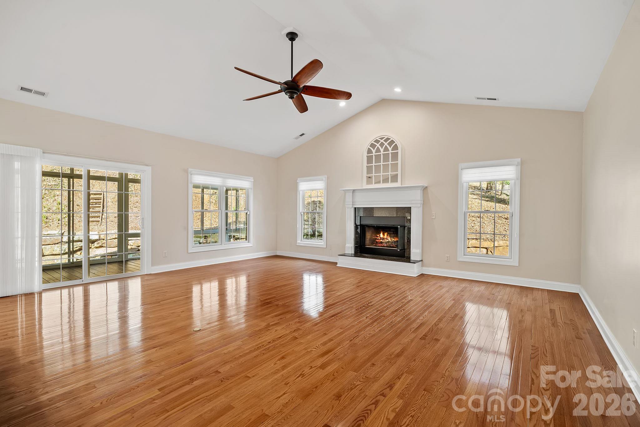 455 Blue Mist Way Arden, NC 28704 - Photo 14 of 46 a view of an empty room with wooden floor and a window