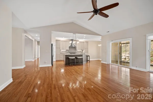a living room with furniture and kitchen view