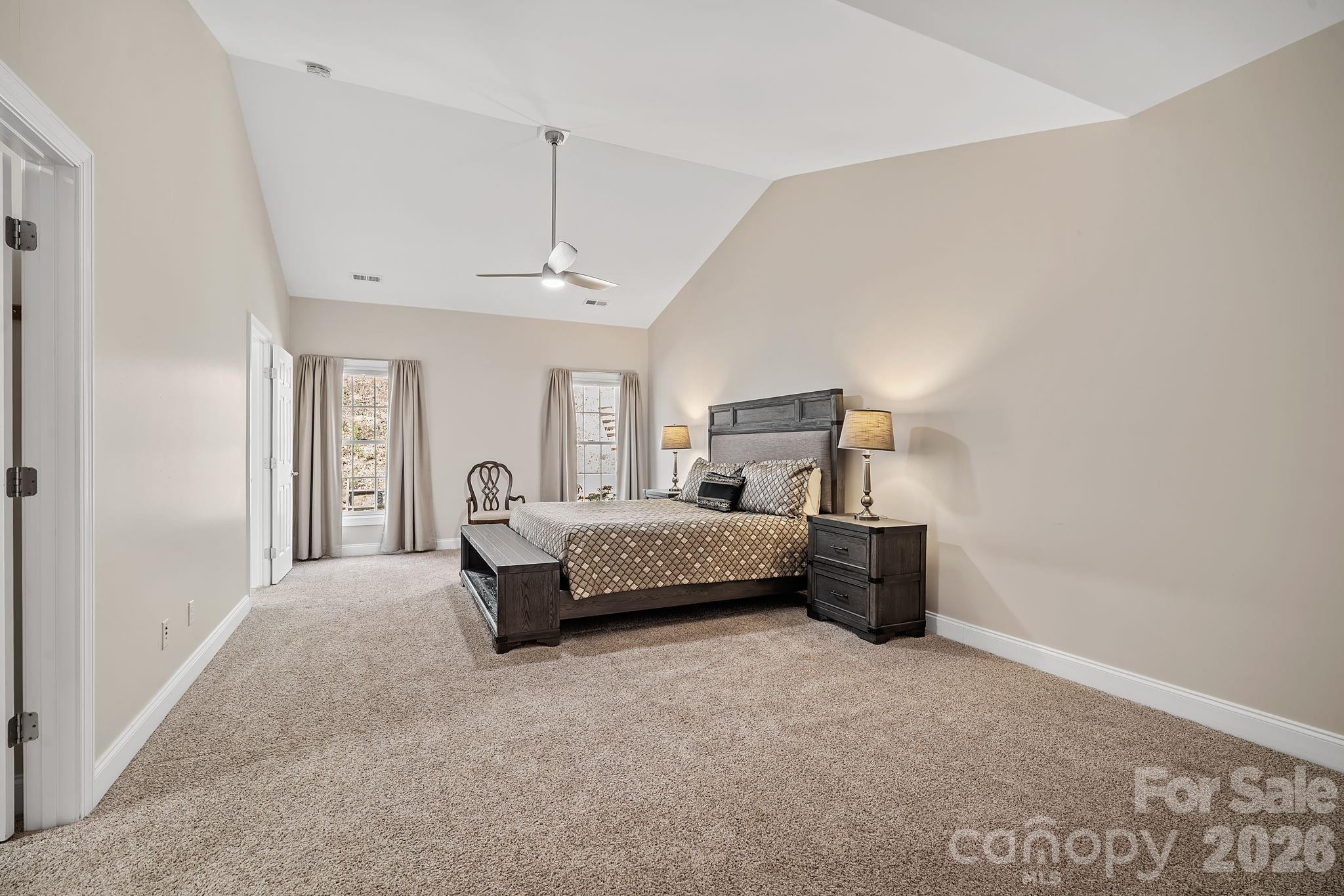 455 Blue Mist Way Arden, NC 28704 - Photo 19 of 46 a bedroom with a bed and a chandelier