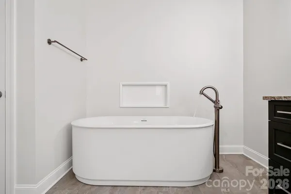 a white bath tub sitting in a bathroom