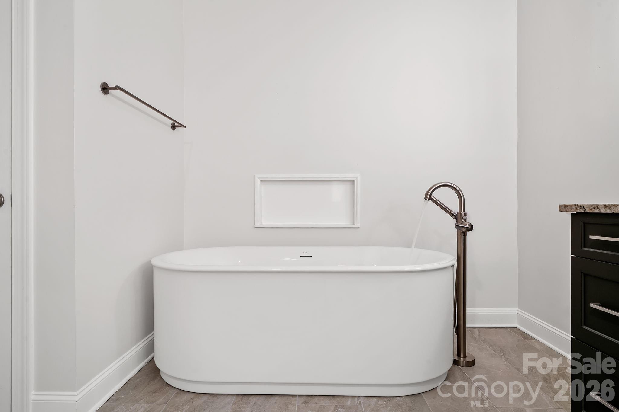 455 Blue Mist Way Arden, NC 28704 - Photo 23 of 46 a white bath tub sitting in a bathroom