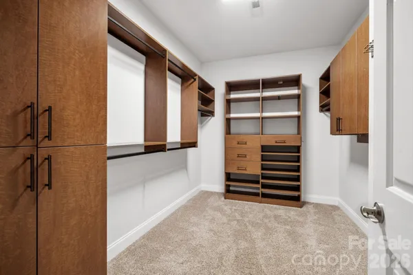 a view of closet area with empty racks