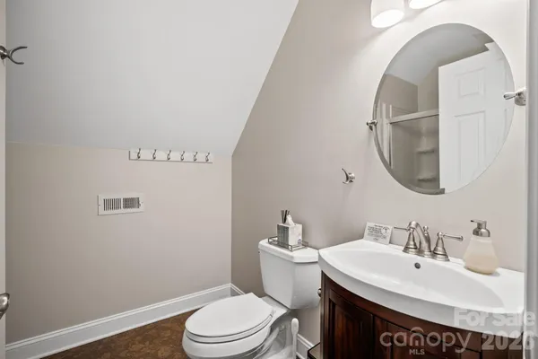 a bathroom with a sink a toilet and a mirror