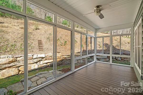 a view of a living room and floor to ceiling window or wooden floor
