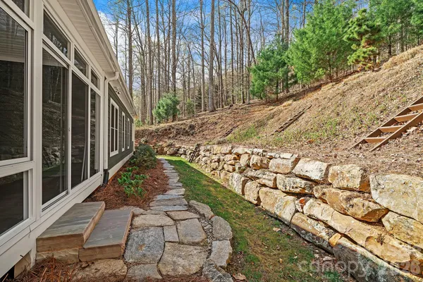 a view of a pathway of a house with a yard
