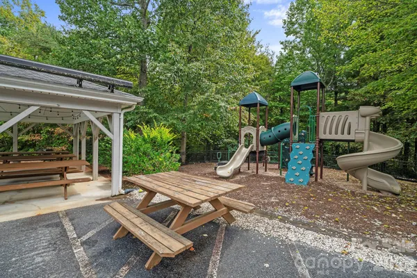 a view of a patio with table and chairs with wooden floor and fence