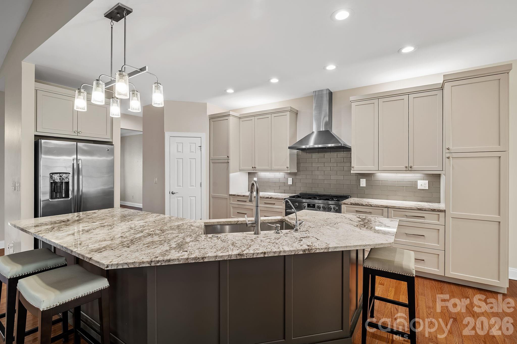 455 Blue Mist Way Arden, NC 28704 - Photo 9 of 46 a kitchen with kitchen island granite countertop a center island a stove cabinets a dining table and chairs