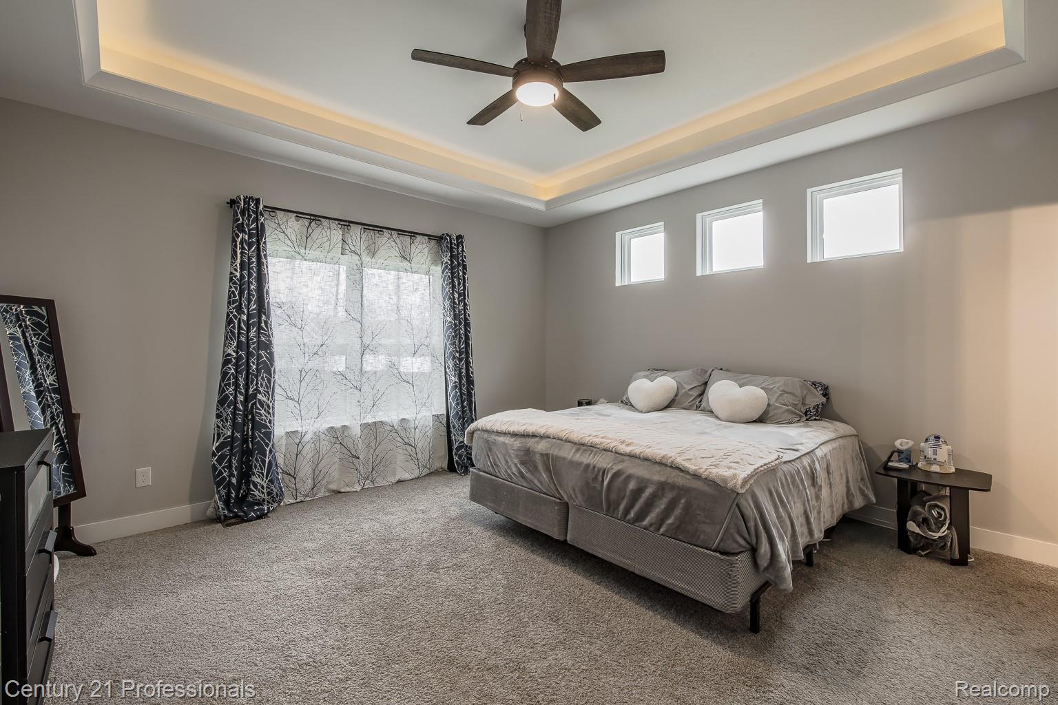 4914 TORATOLA Lane Howell, MI 48843 - Photo 21 of 39 Bedroom with a raised ceiling, a ceiling fan, and carpet