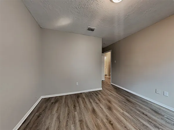 a view of room with wooden floor