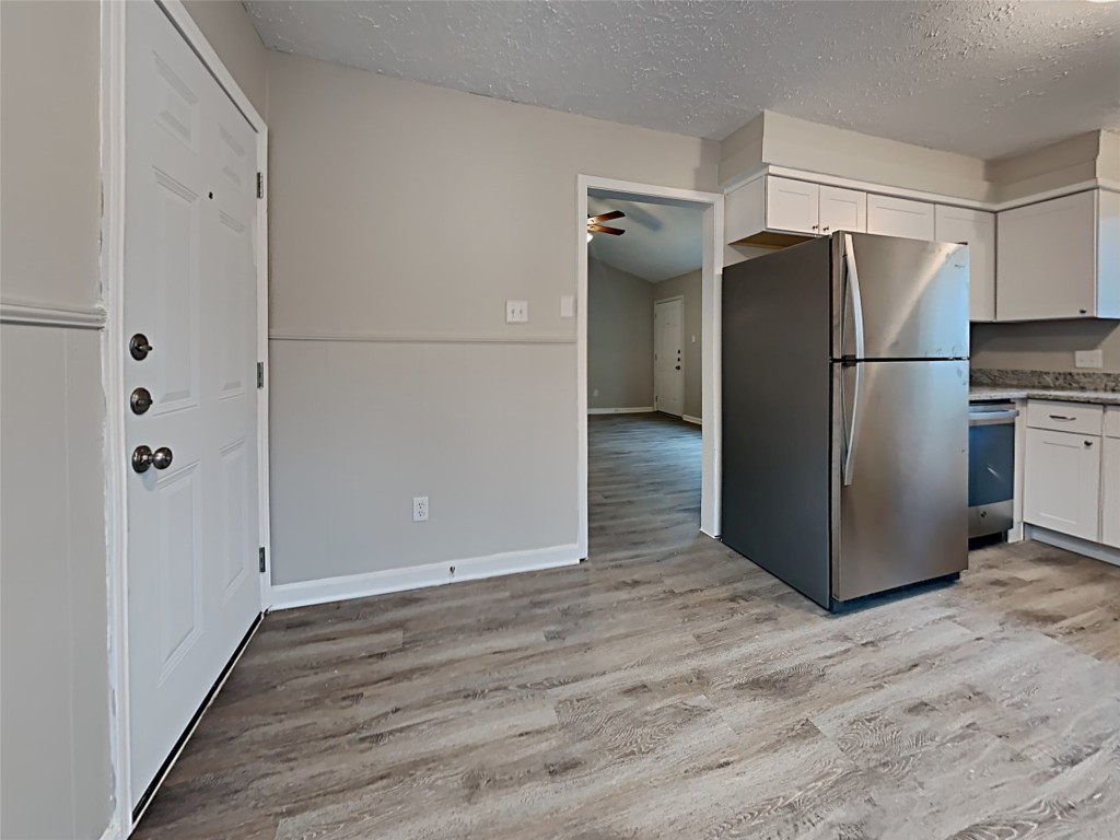 15914 Ridgeroe Lane Houston, TX 77053 - Photo 5 of 18 a view of a refrigerator in kitchen and white cabinets