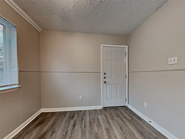 a view of a room with wooden floor