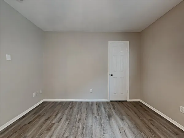 a view of an empty room and wooden floor