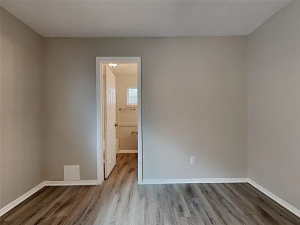 a view of wooden floor and closet in a room