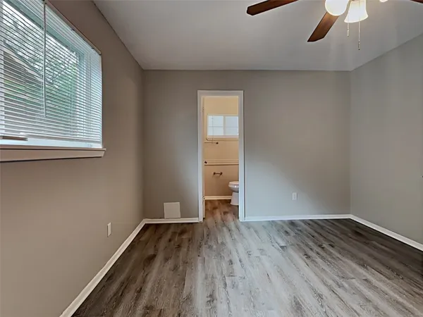 a view of a room with wooden floor and a window
