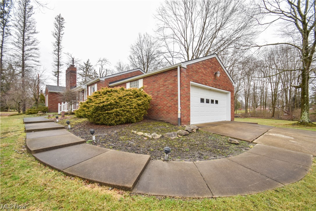 View of property exterior with a yard