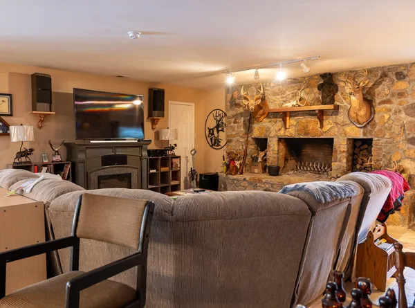 a living room with furniture a flat screen tv and a fireplace