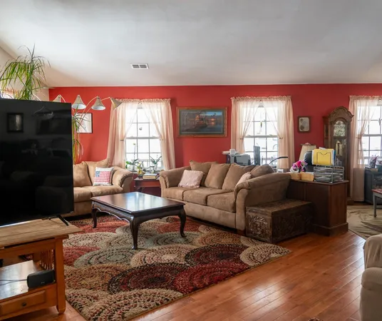 a living room with furniture a fireplace and a window