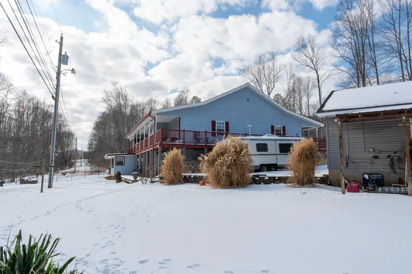 a view of a house with a snow in a yard