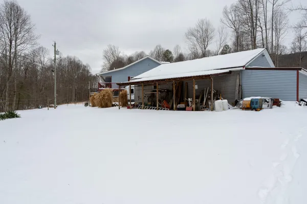 a view of a house with a snow in the yard