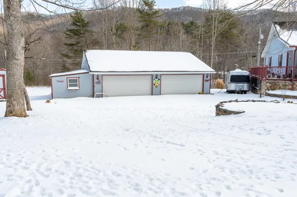 a view of a house with snow on the road